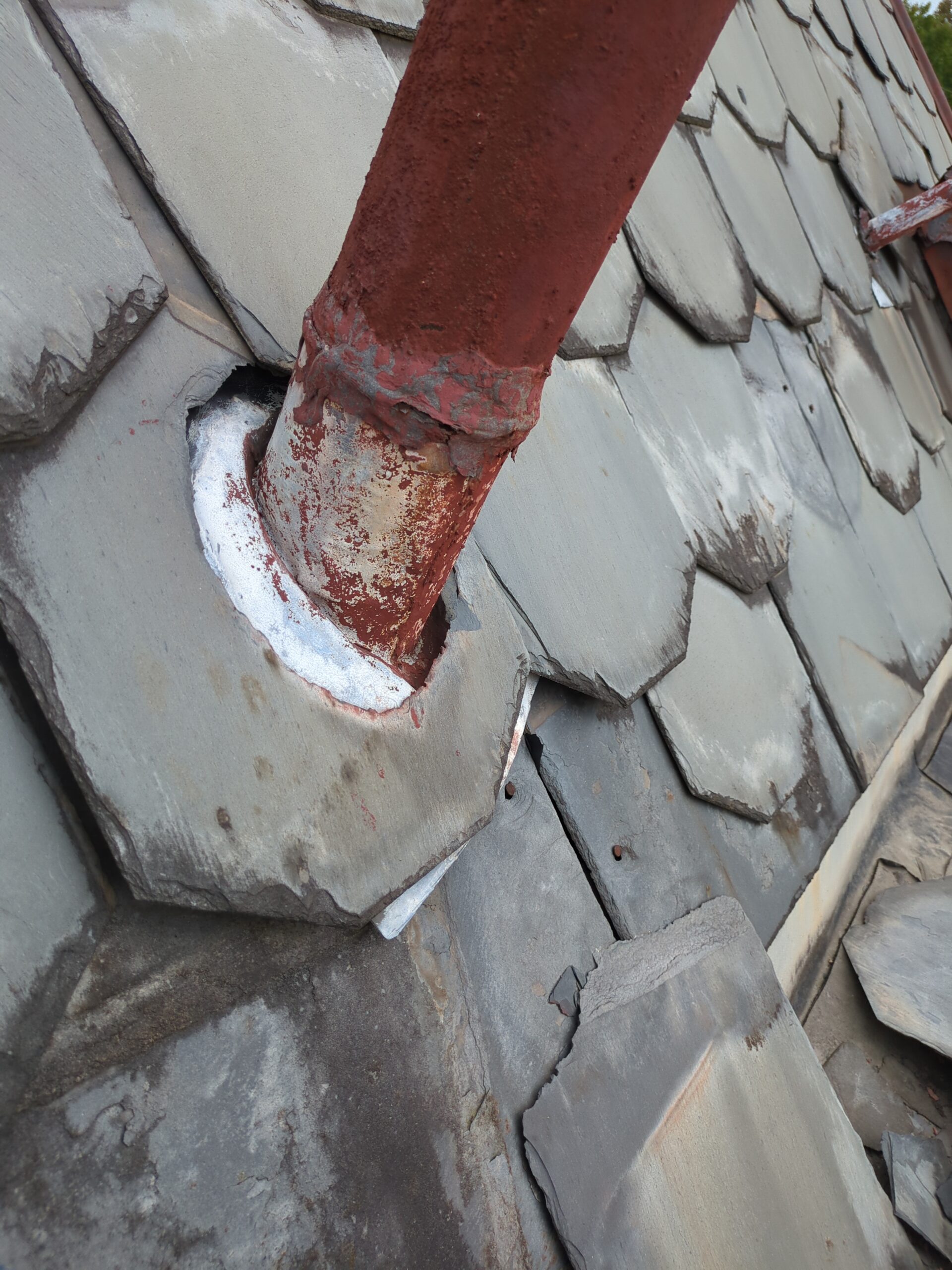 Repairing metal vent pipe on a slate roof