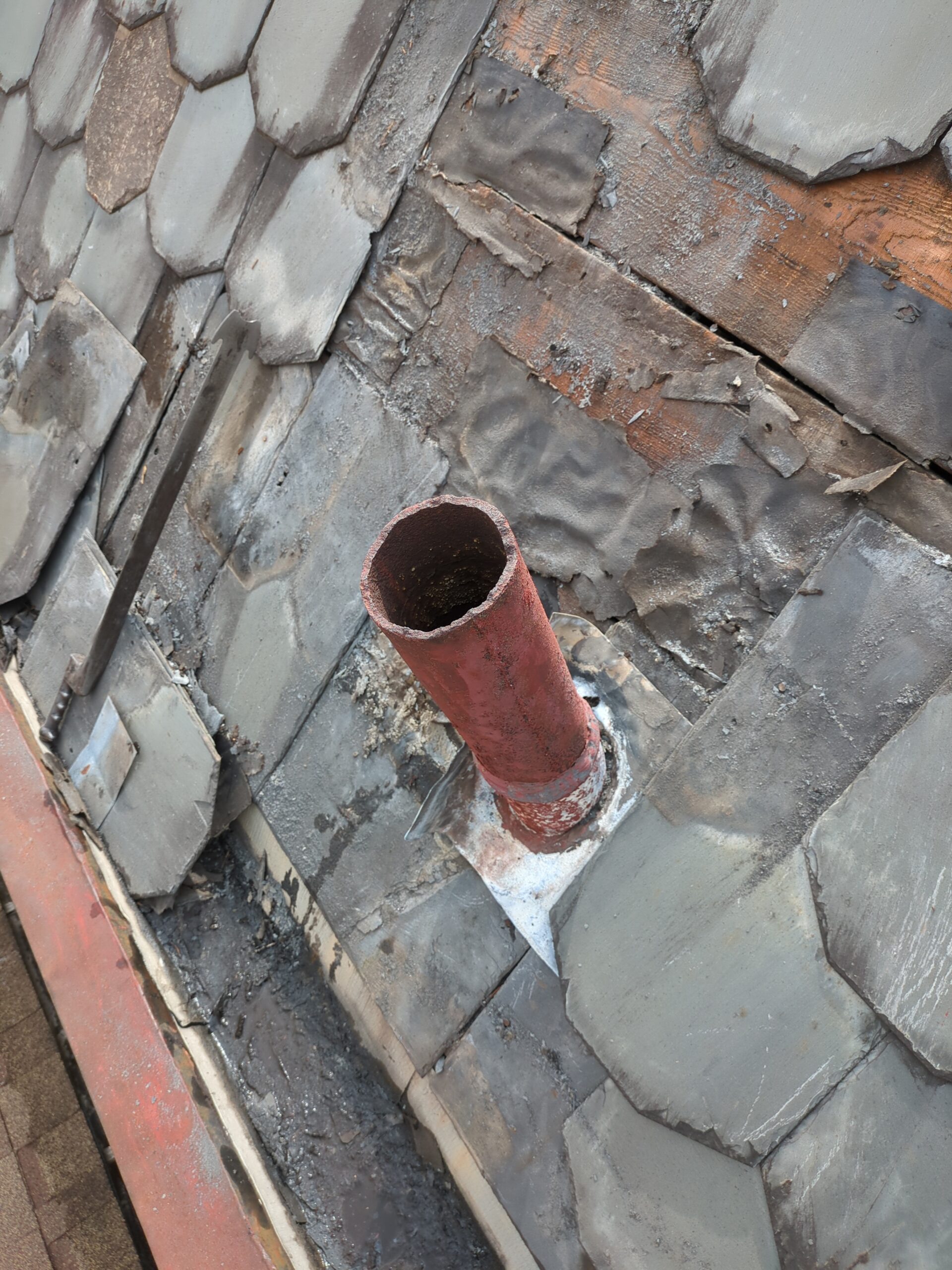 copper-roof-pipe-restoration Restoring copper pipe detail on an older slate roof